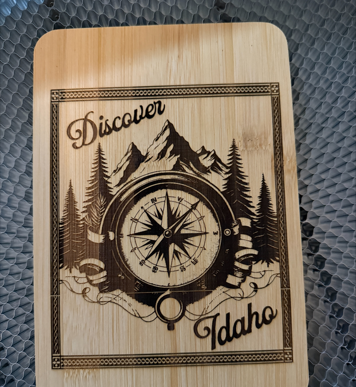 Bamboo cutting board with laser-engraved Idaho mountain and compass design, rustic farmhouse style