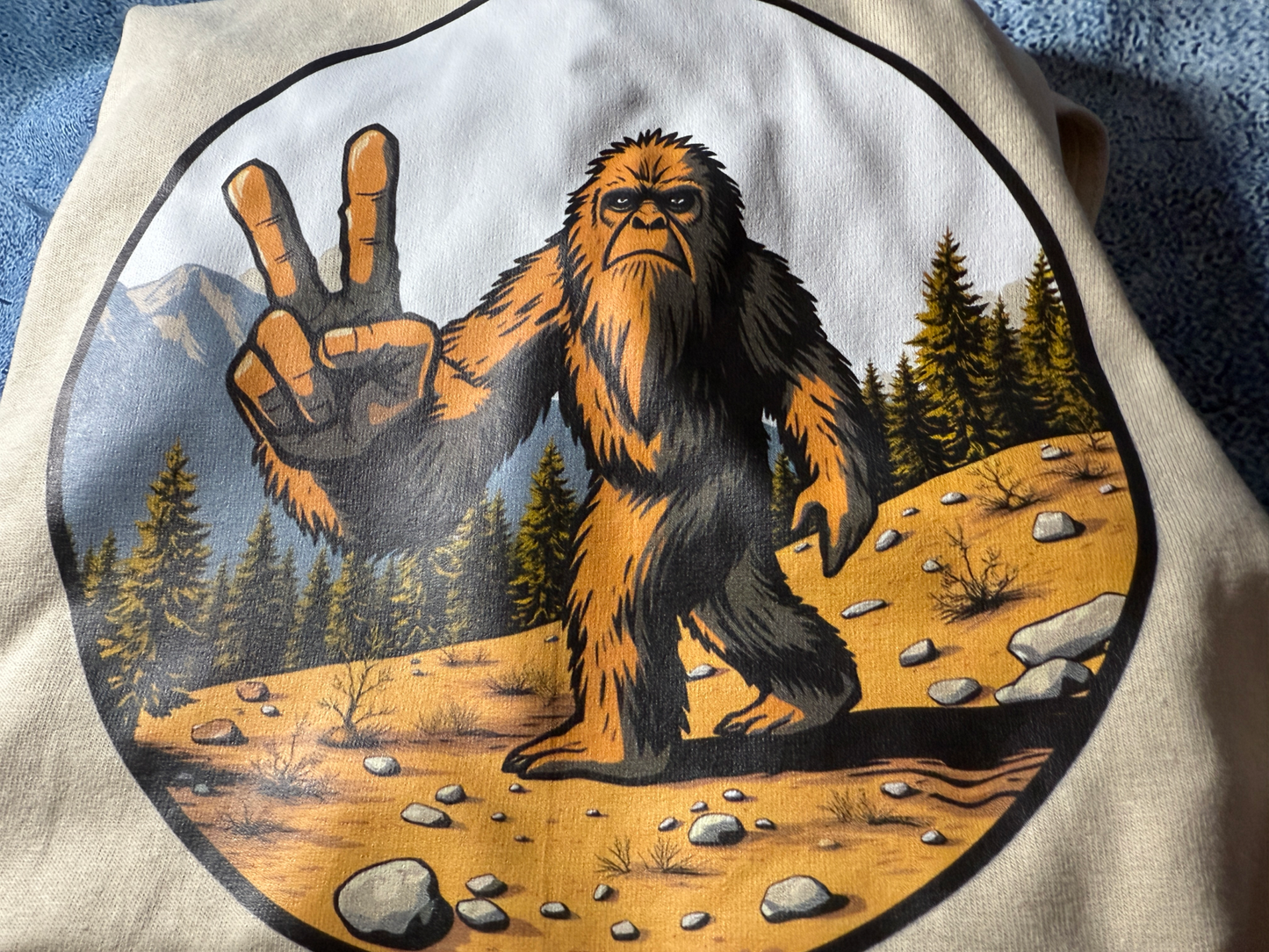Peace Out Bigfoot Tee with Bigfoot flashing peace sign in forest design on soft cotton fabric