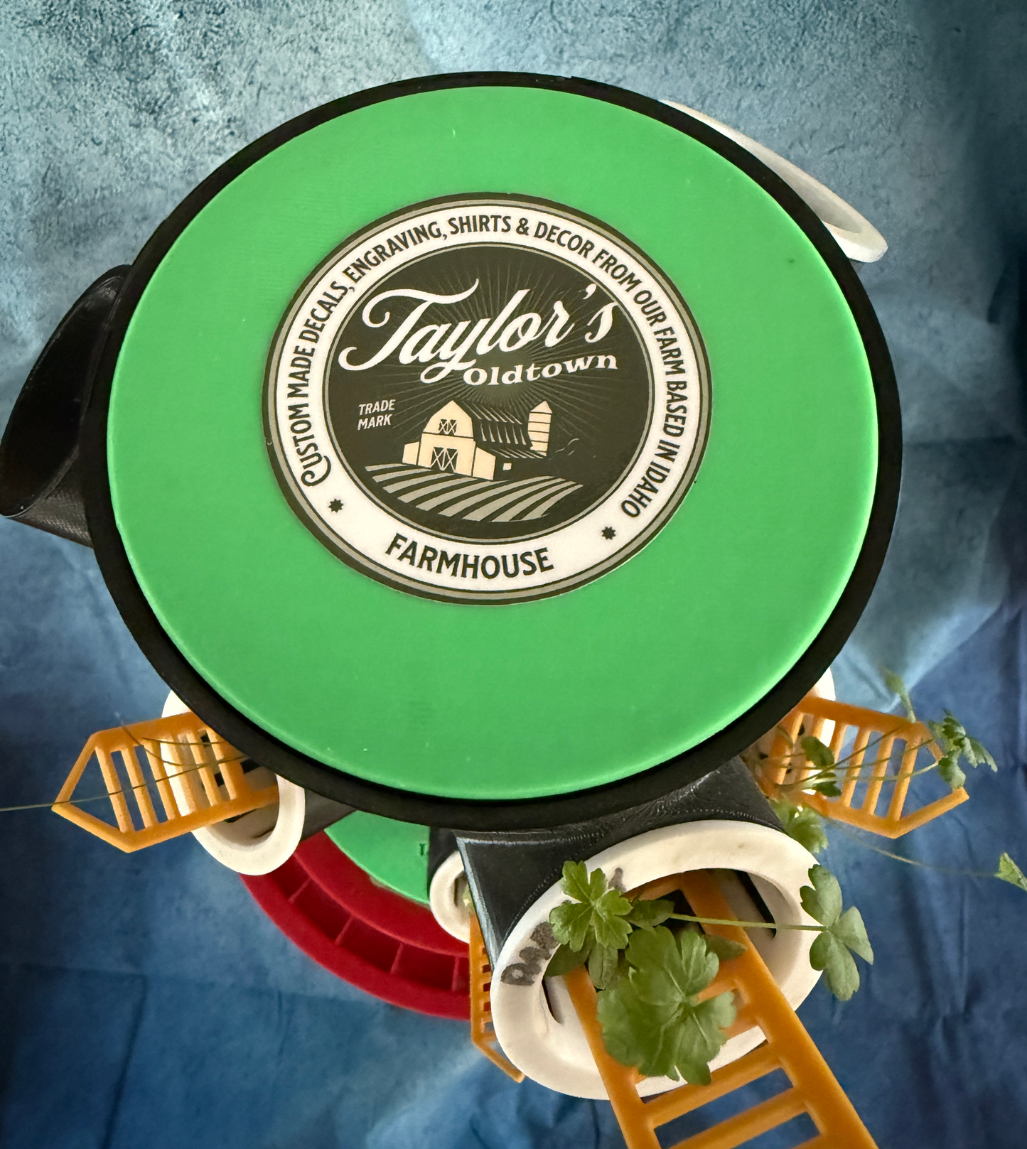 Green lid with 'Taylor's Oldtown Farmhouse' logo on it  a blue background